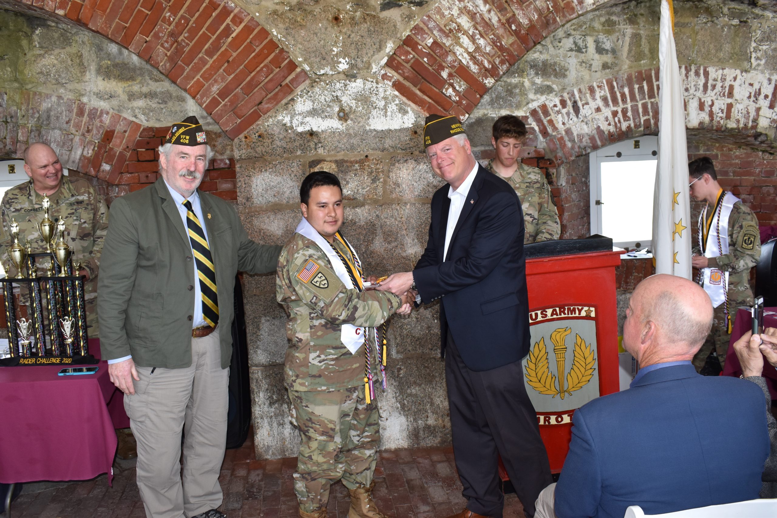 SFC Farrell and CAPT Turn presenting Cadet Garcia Munoz a medal and certificate for outstanding achievement.